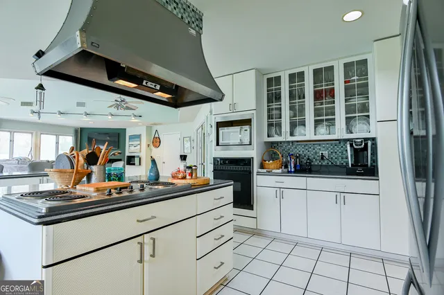 a kitchen with stainless steel appliances granite countertop a sink and cabinets