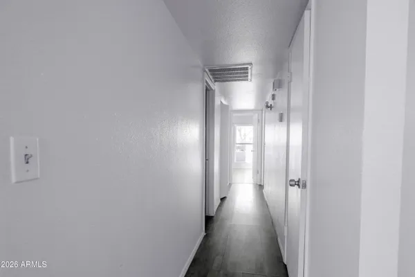 a view of a hallway with wooden floor