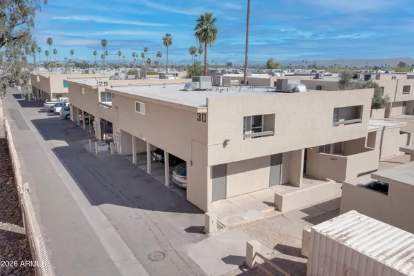 a view of a patio with dining table and chairs