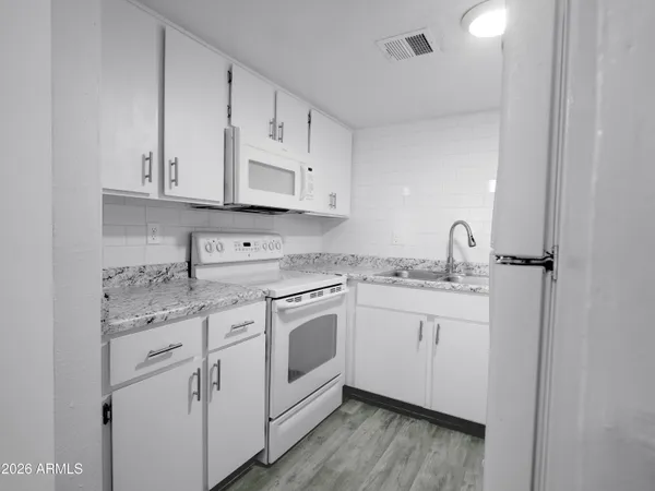 a kitchen with appliances cabinets and a sink