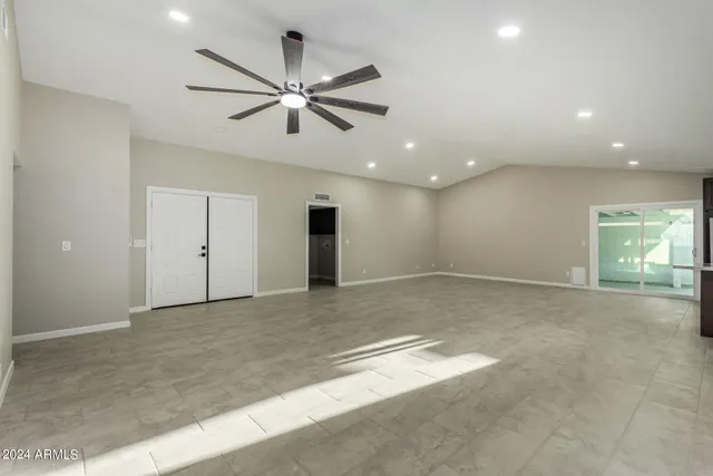 a kitchen with granite countertop stainless steel appliances a sink stove and cabinets