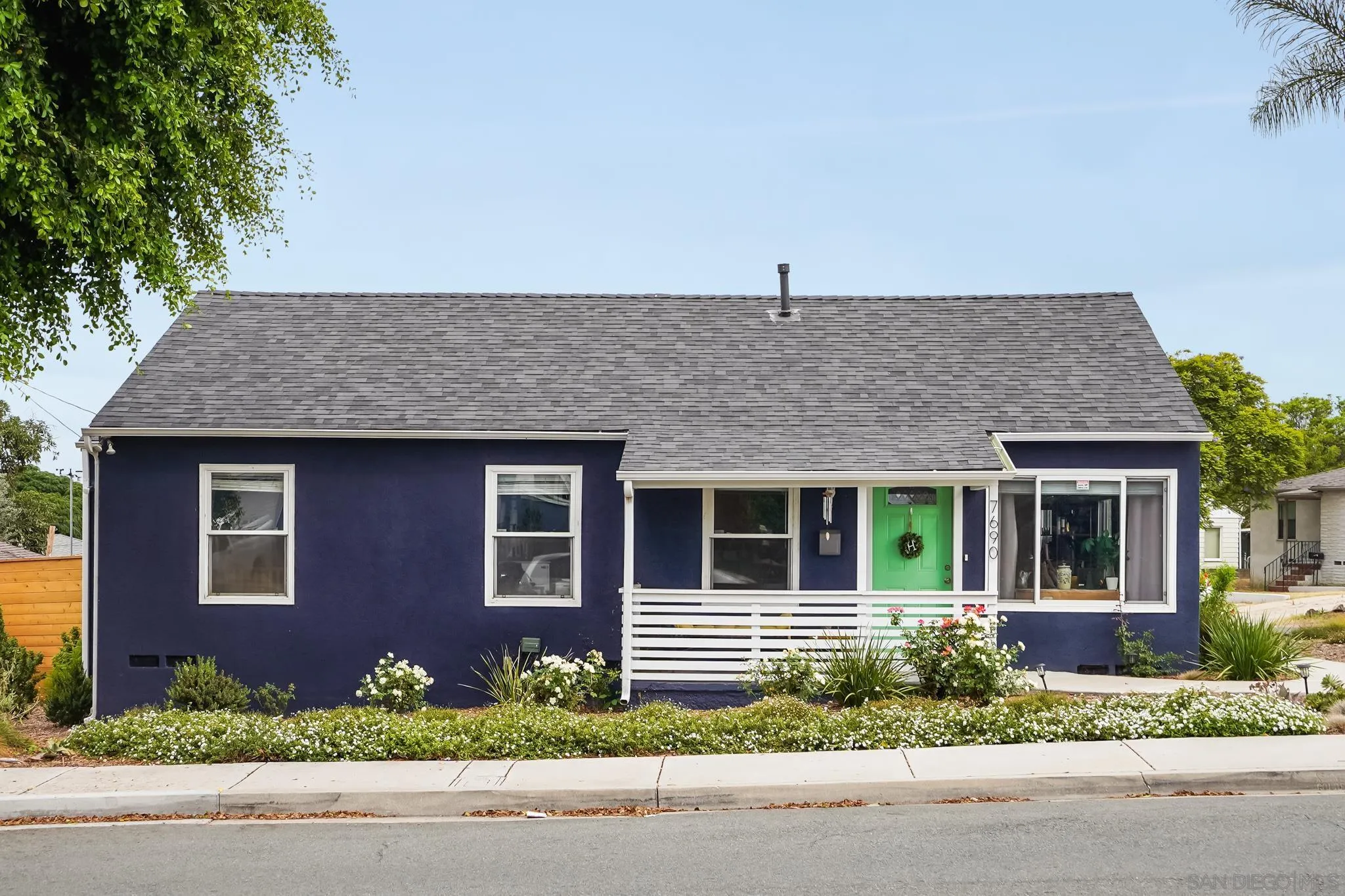 7690 Canton Drive Lemon Grove, CA 91945 - Photo 2 of 41 a front view of a house with a yard and garage
