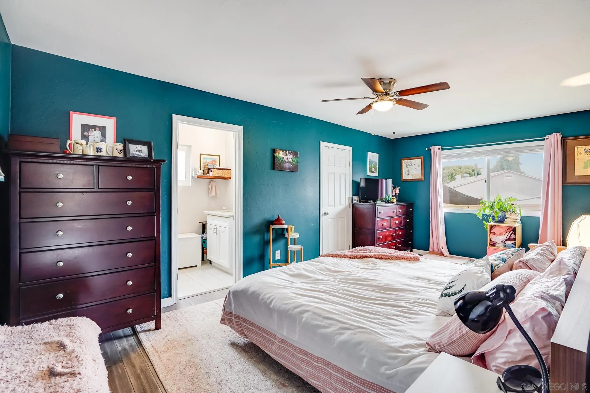 7690 Canton Drive Lemon Grove, CA 91945 - Photo 23 of 41 a bedroom with a bed window and a ceiling fan