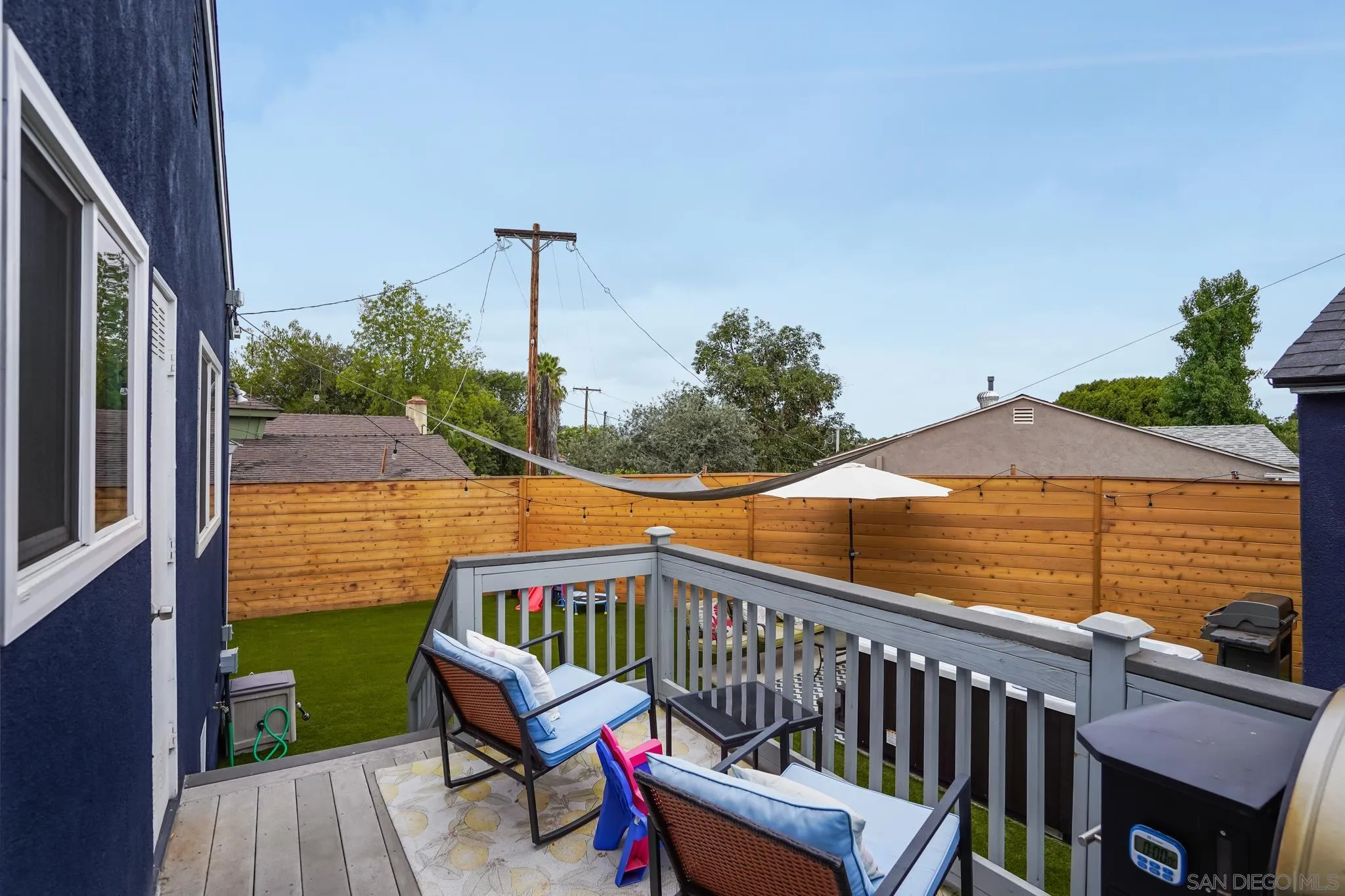 7690 Canton Drive Lemon Grove, CA 91945 - Photo 41 of 41 a view of a roof deck with table and chairs with wooden floor and fence