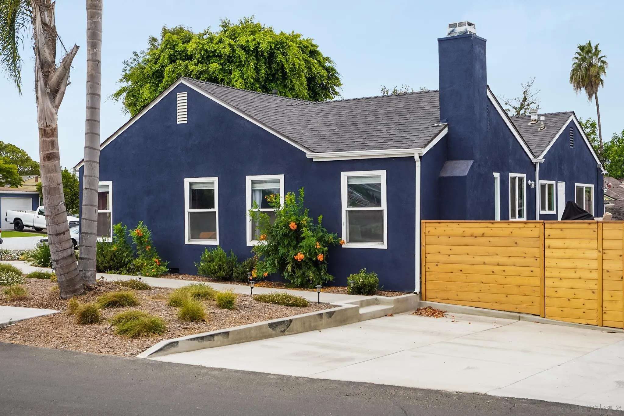 7690 Canton Drive Lemon Grove, CA 91945 - Photo 5 of 41 a front view of a house with a yard and garage