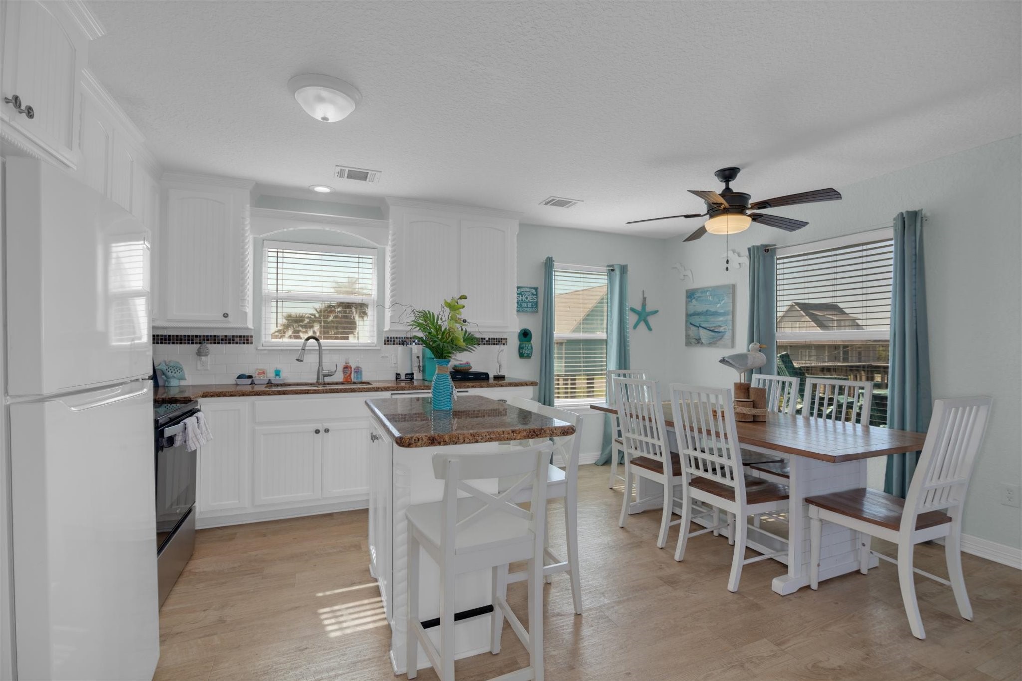 422 Jettyview Road Freeport, TX 77541 - Photo 8 of 37 a kitchen with a dining table chairs cabinets and stainless steel appliances