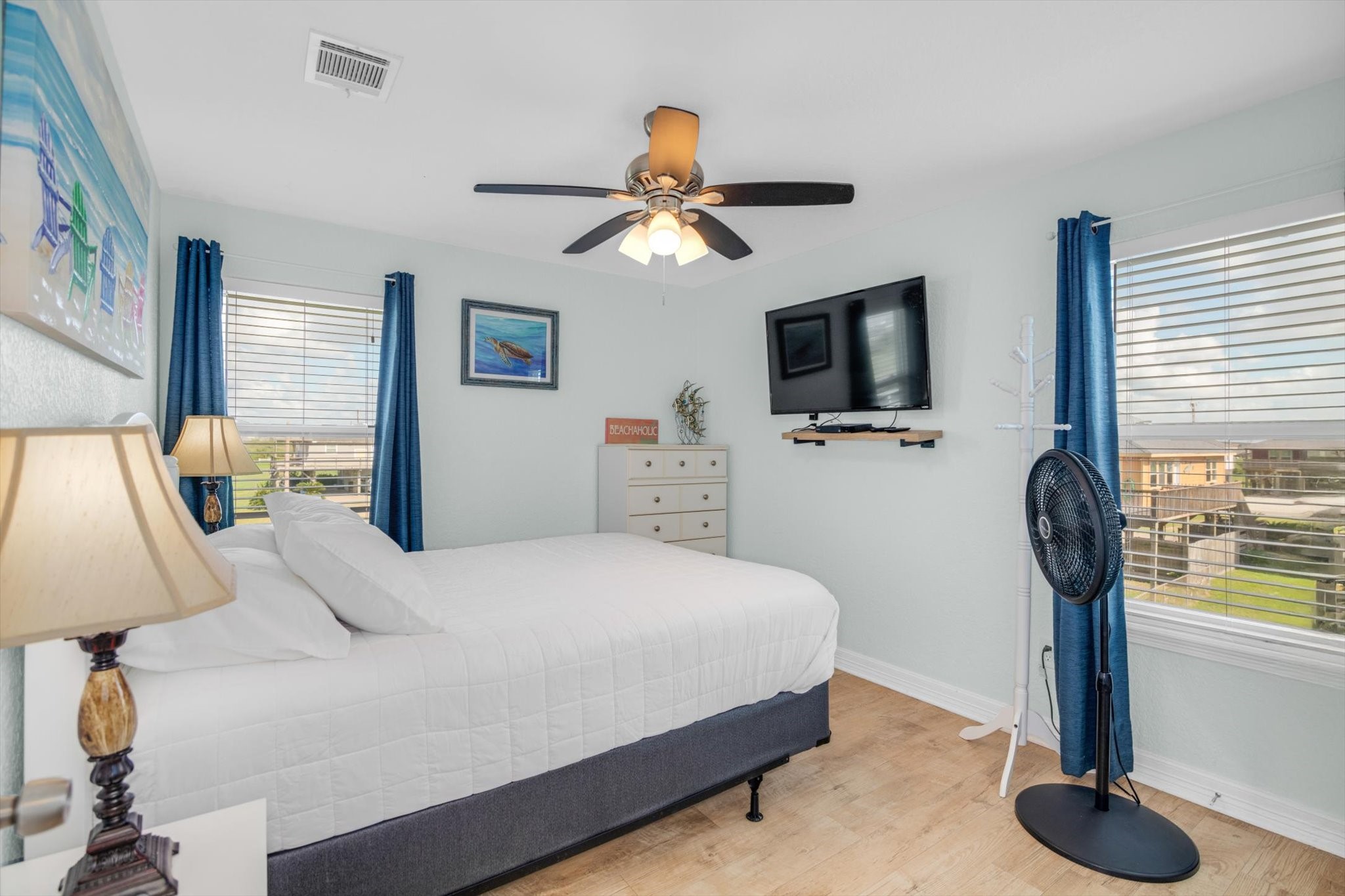 422 Jettyview Road Freeport, TX 77541 - Photo 10 of 37 a bedroom with a bed and a flat tv screen on dresser