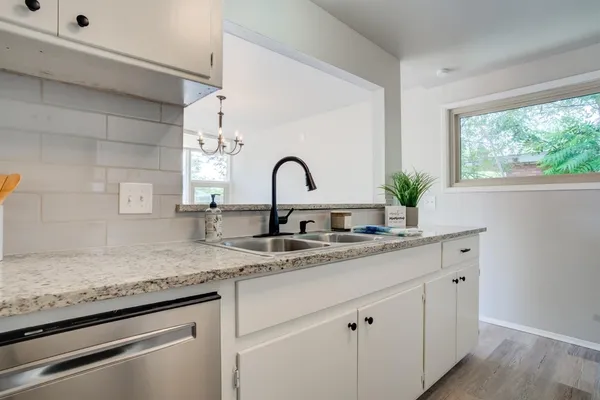a kitchen with granite countertop a sink and a window