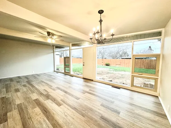 a view of a room with wooden floor