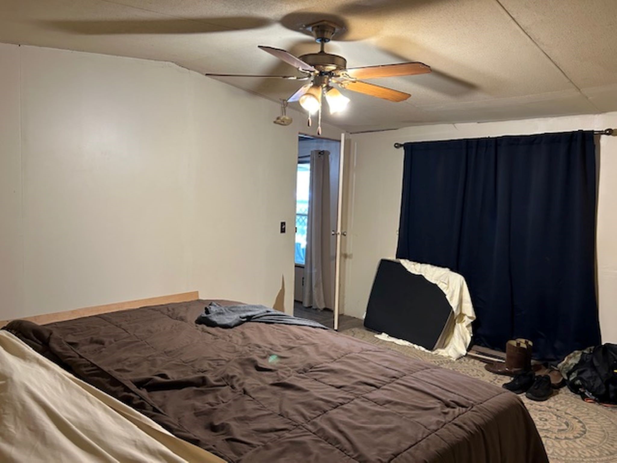 30996 Strathmore Road Waller, TX 77484 - Photo 12 of 20 a bedroom with a bed and a chandelier