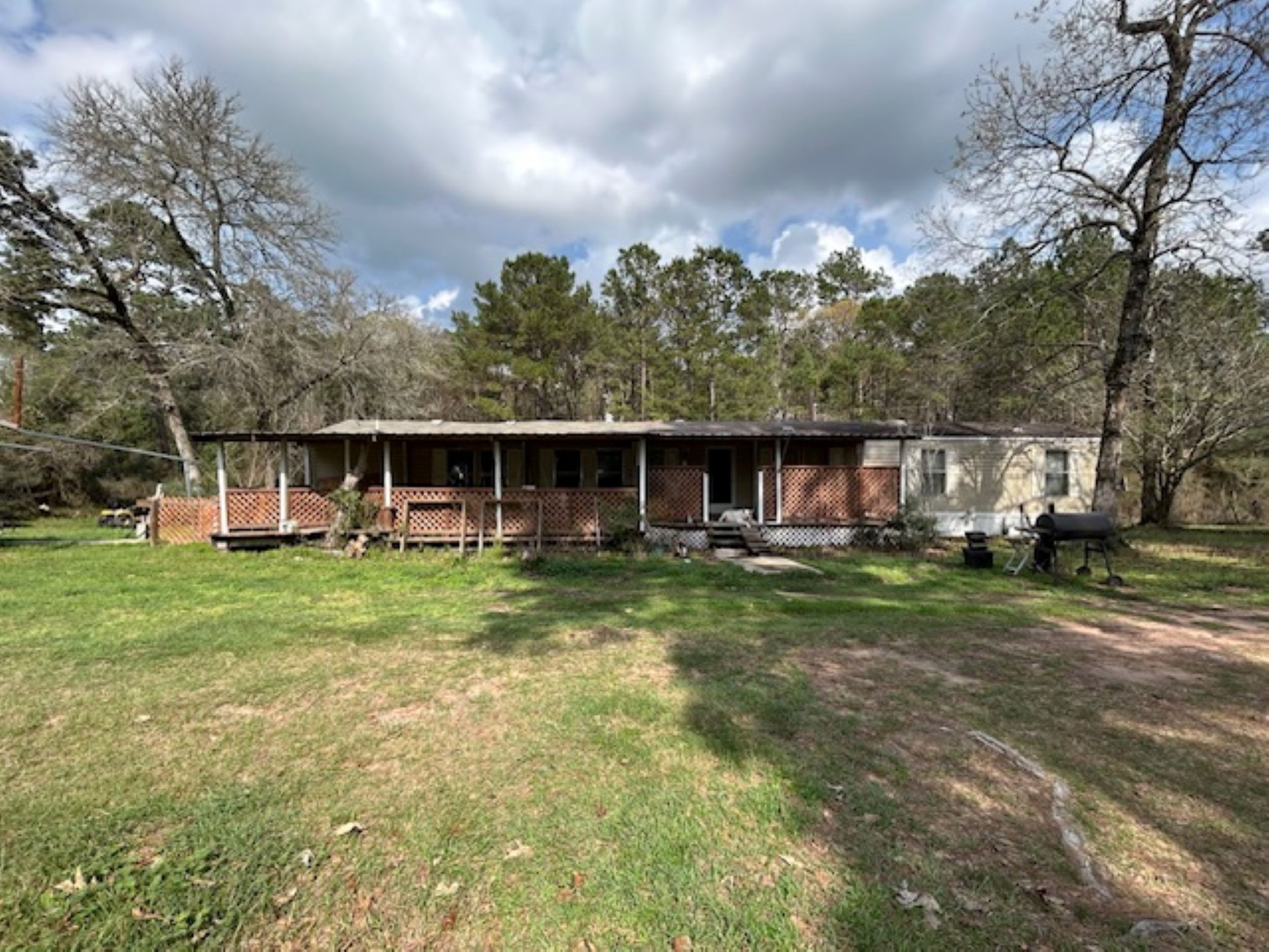 30996 Strathmore Road Waller, TX 77484 - Photo 3 of 20 a view of a house with a yard and sitting area