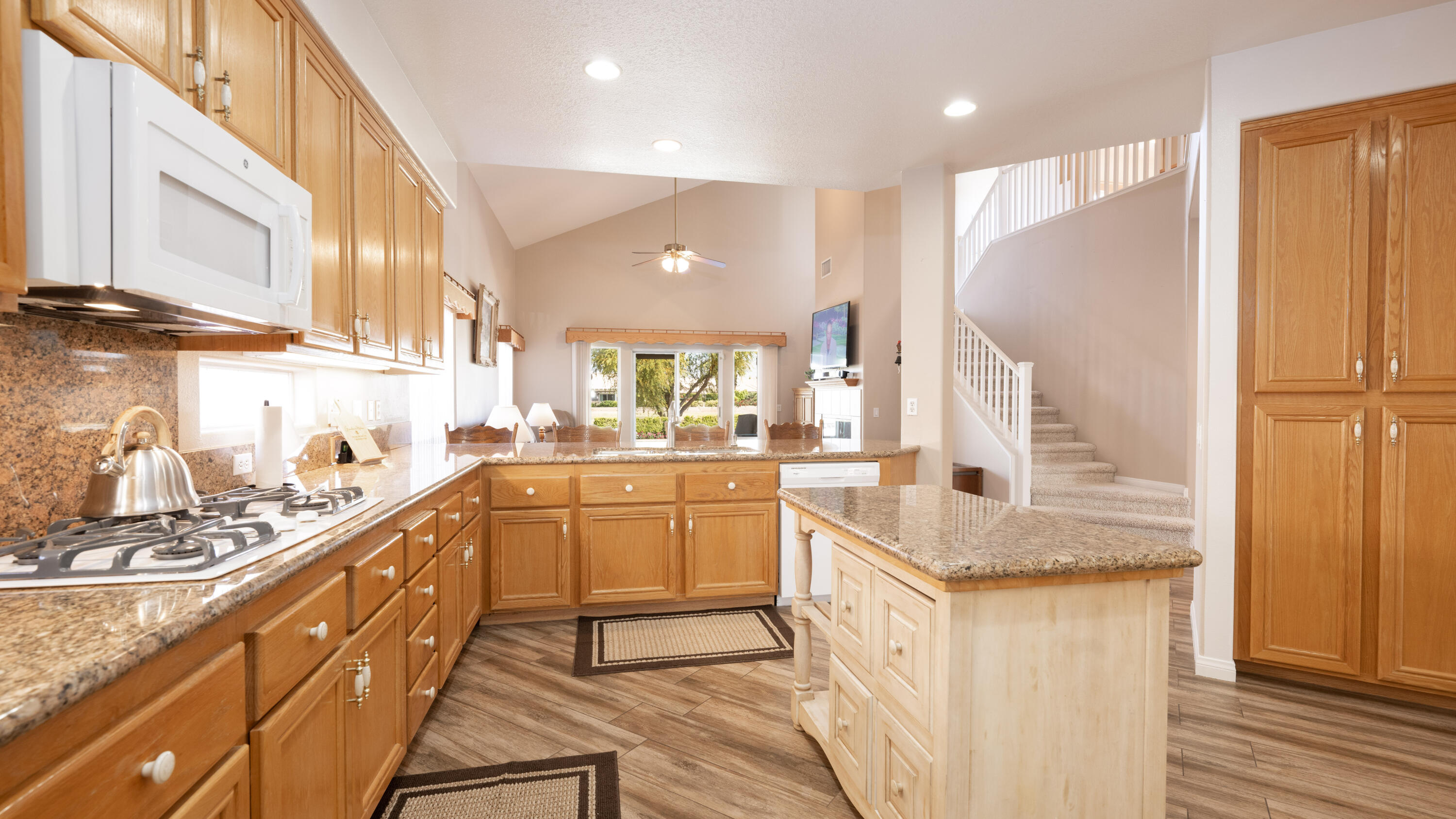 80432 Pebble Beach Drive Indio, CA 92201 - Photo 14 of 46 a kitchen with stainless steel appliances granite countertop a sink a stove and a refrigerator