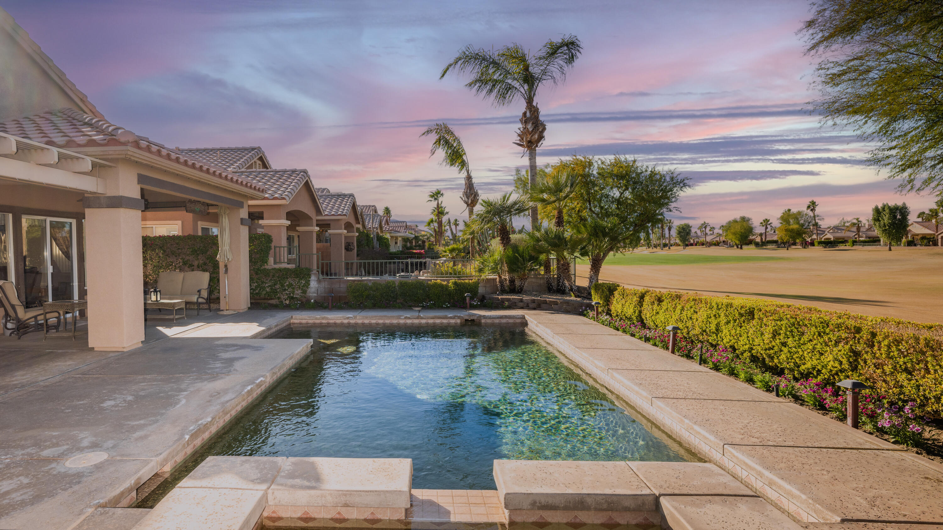 80432 Pebble Beach Drive Indio, CA 92201 - Photo 2 of 46 a view of a swimming pool with an outdoor seating
