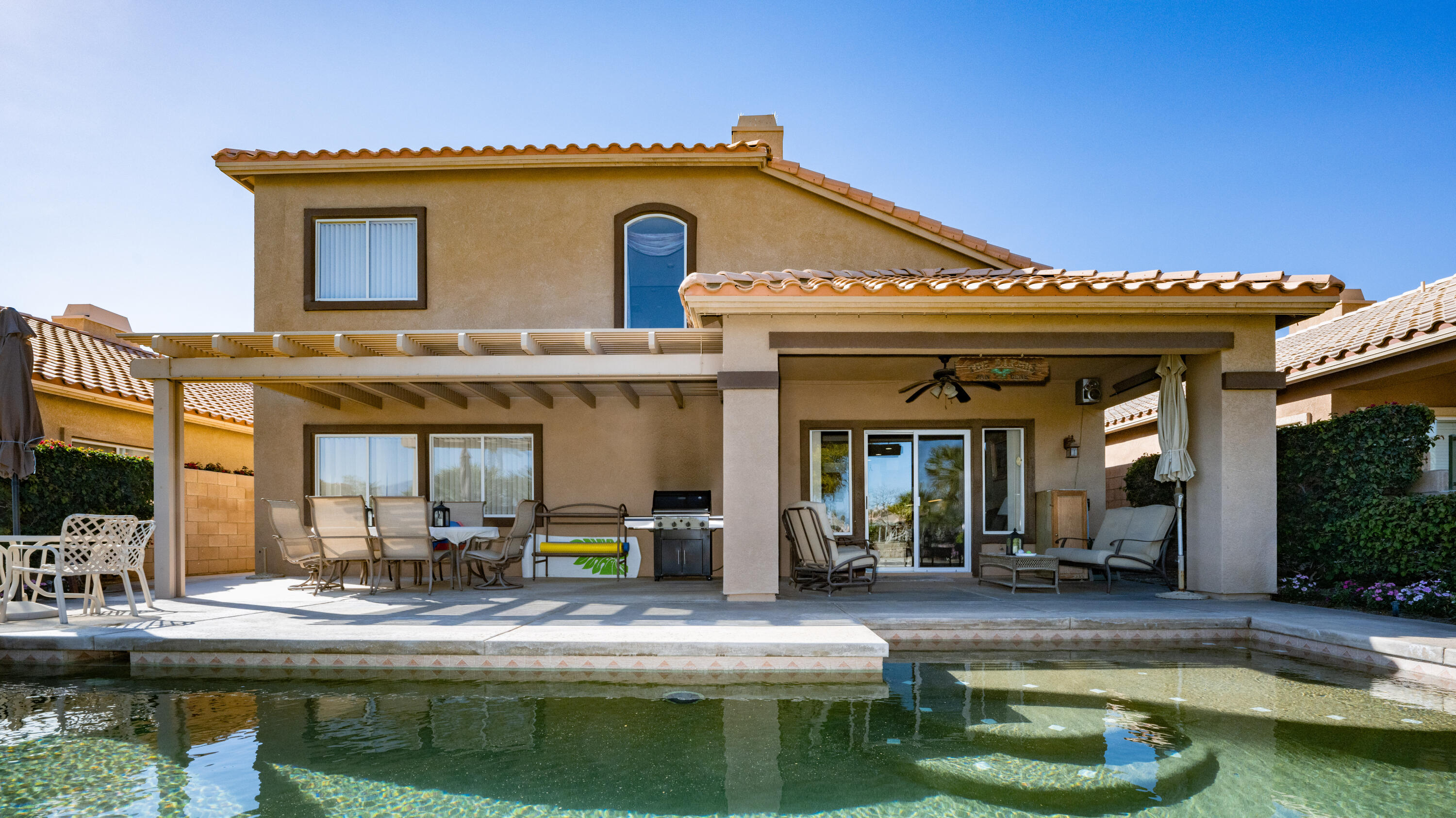 80432 Pebble Beach Drive Indio, CA 92201 - Photo 25 of 46 a view of a house with swimming pool and furniture