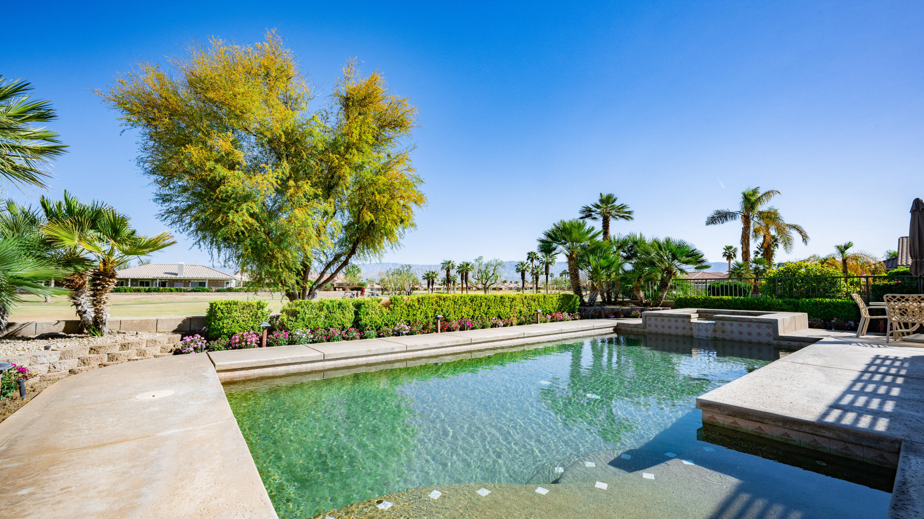 80432 Pebble Beach Drive Indio, CA 92201 - Photo 26 of 46 a view of a lake with a house in the background