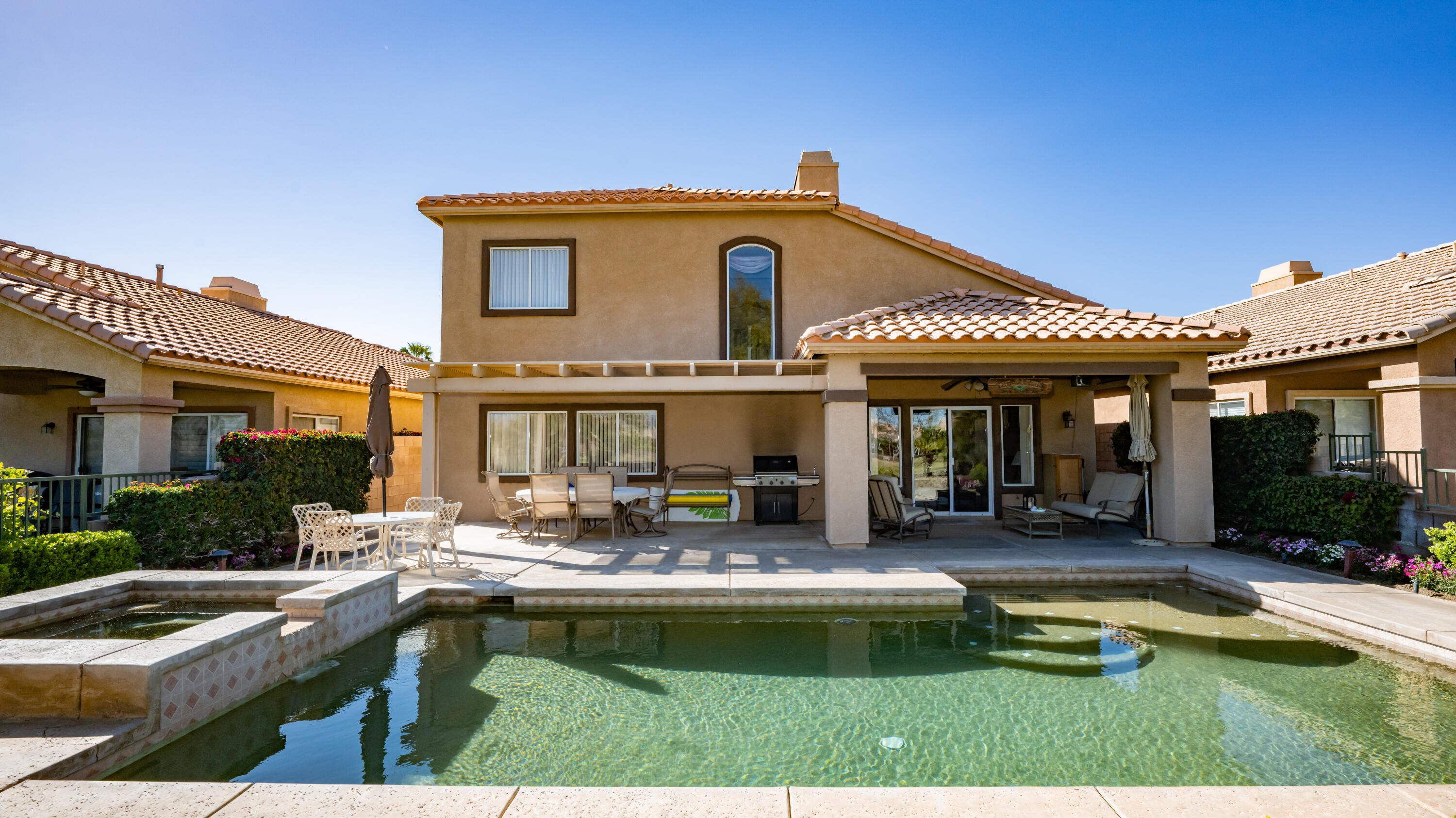80432 Pebble Beach Drive Indio, CA 92201 - Photo 30 of 46 a view of a house with swimming pool and furniture