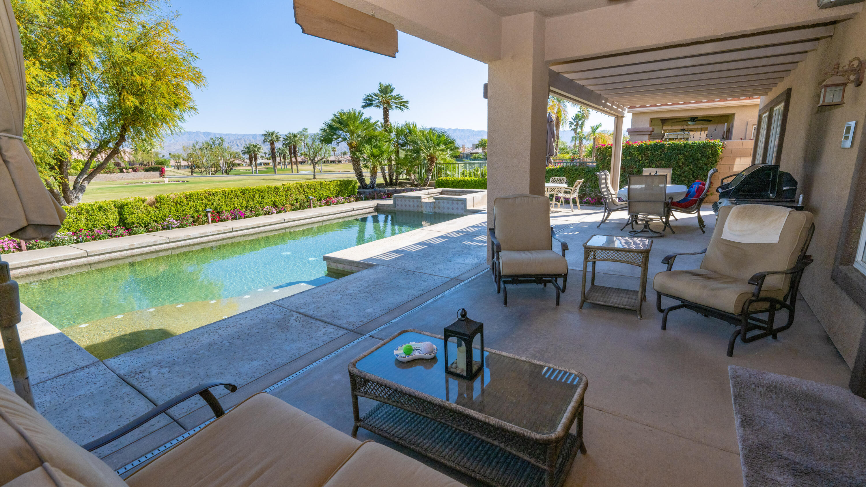 80432 Pebble Beach Drive Indio, CA 92201 - Photo 31 of 46 a view of a chairs and table in patio with a backyard