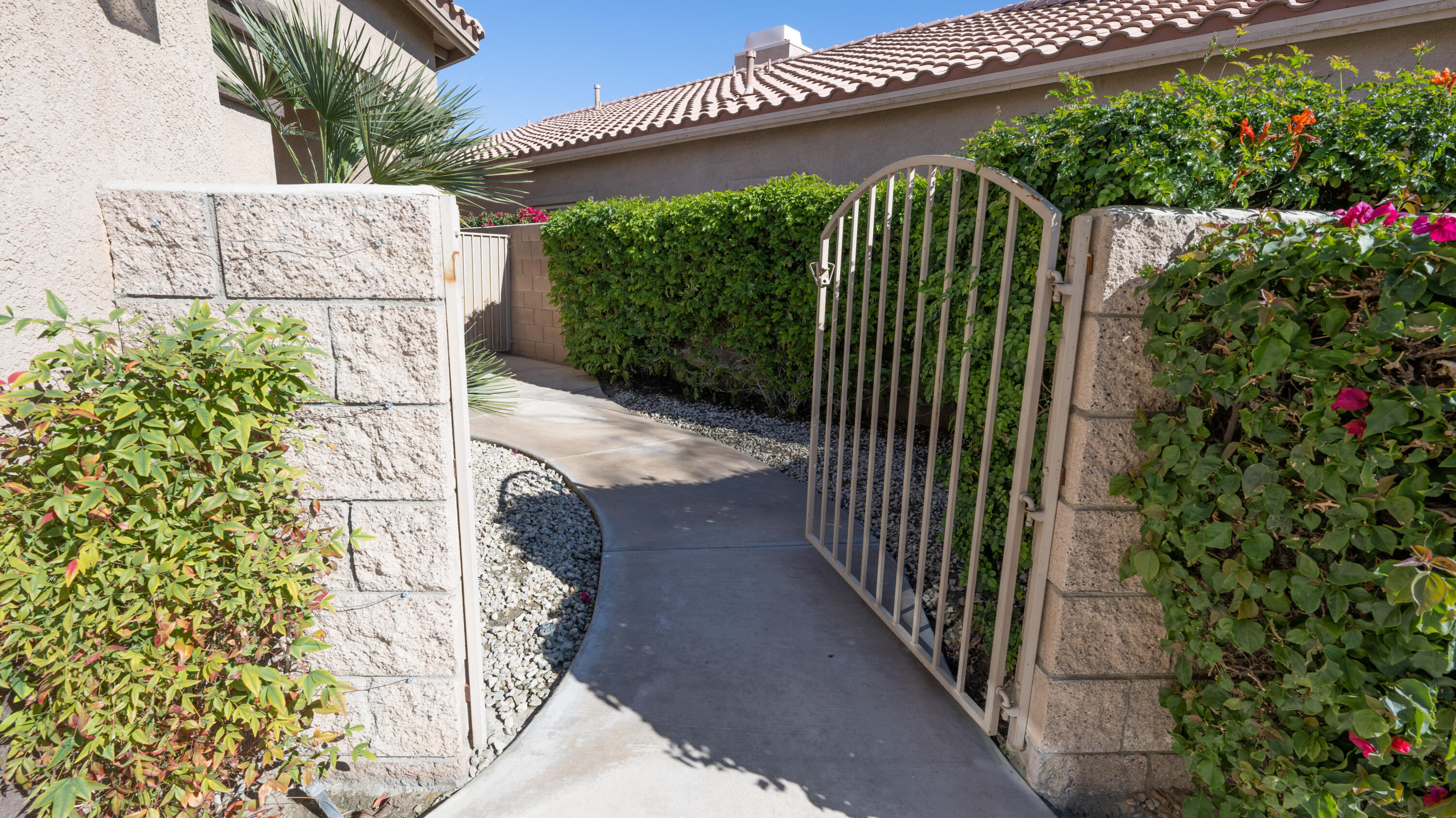 80432 Pebble Beach Drive Indio, CA 92201 - Photo 5 of 46 a view of a garden with a building in the background