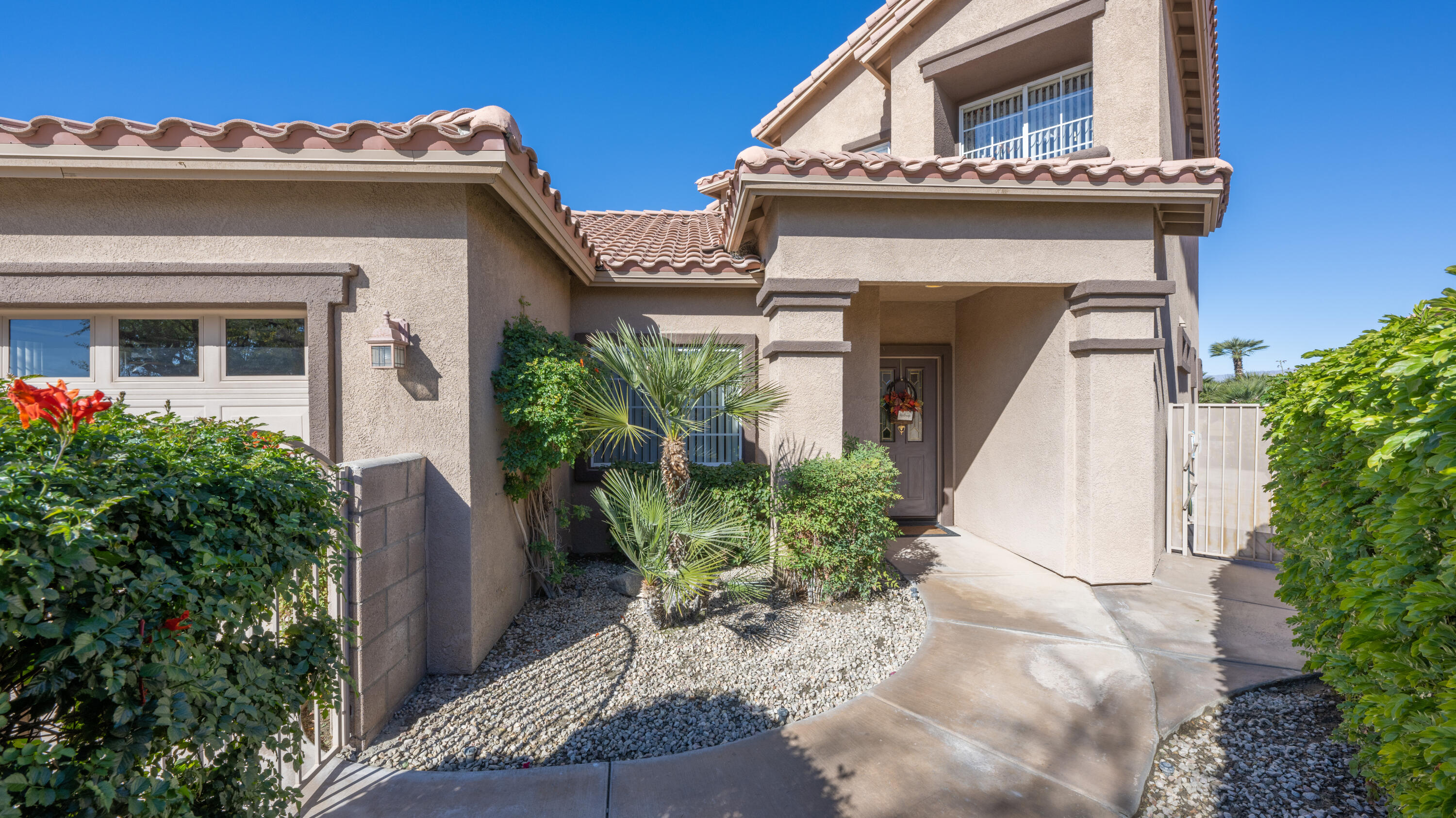 80432 Pebble Beach Drive Indio, CA 92201 - Photo 6 of 46 a view of a house with a potted plant and floor to ceiling window