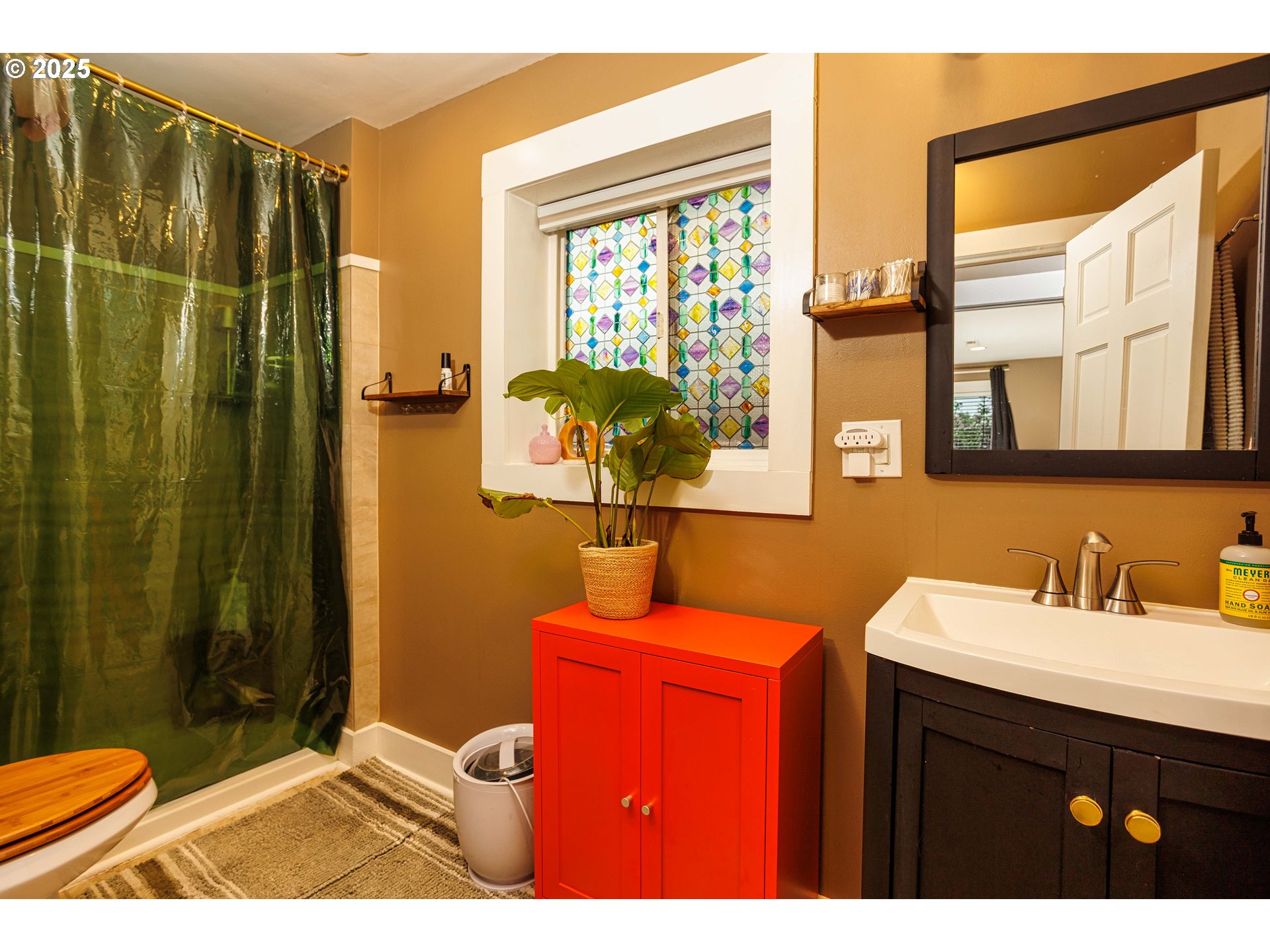 11511 Southeast Division Street Portland, OR 97266 - Photo 12 of 21 a bathroom with a sink vanity mirror and a shower
