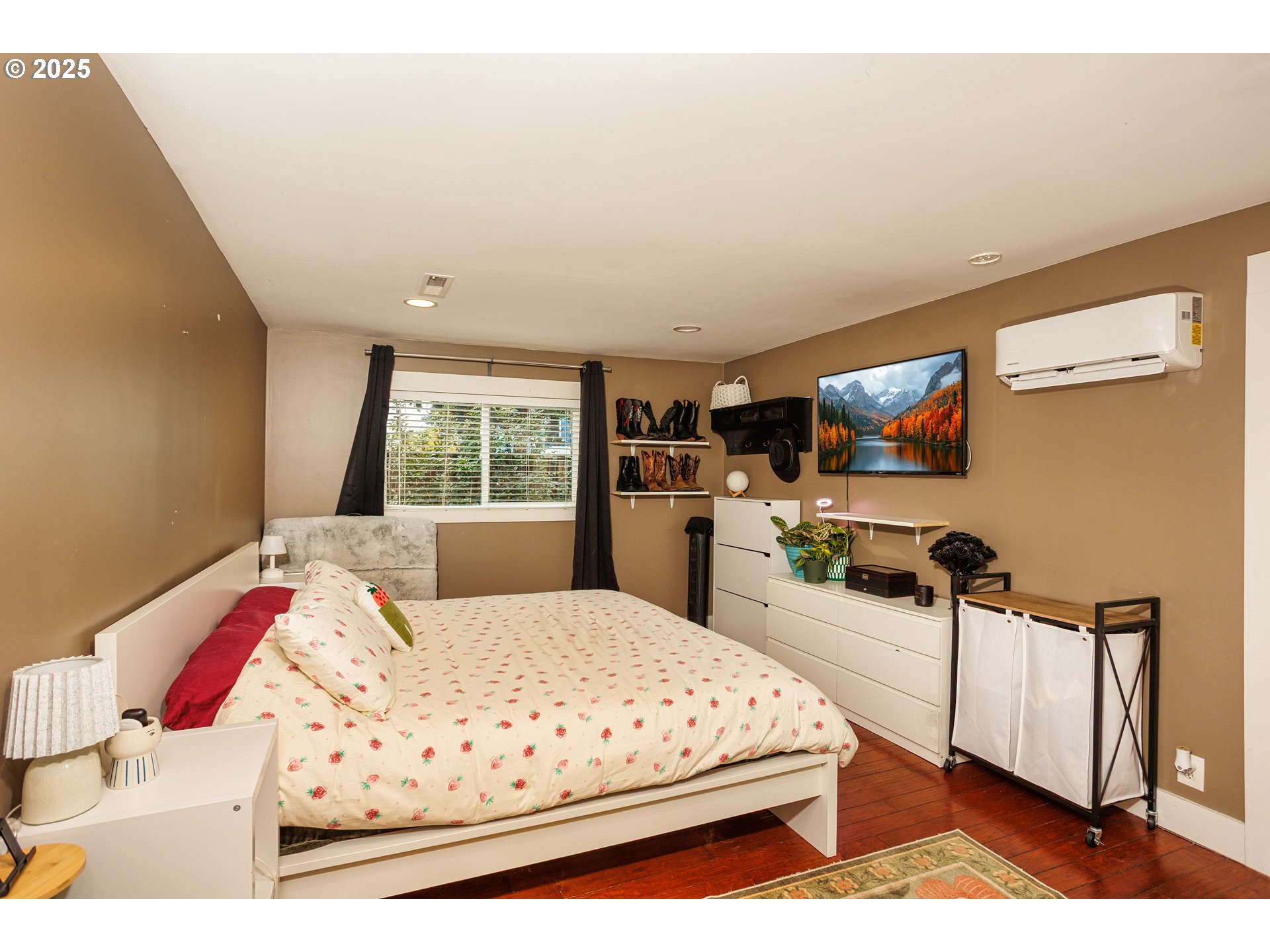 11511 Southeast Division Street Portland, OR 97266 - Photo 10 of 21 a large bedroom with a bed and a flat screen tv