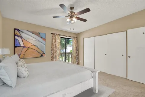 an aerial view of a house with a yard and lake view