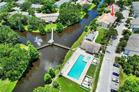an aerial view of residential houses with outdoor space and trees