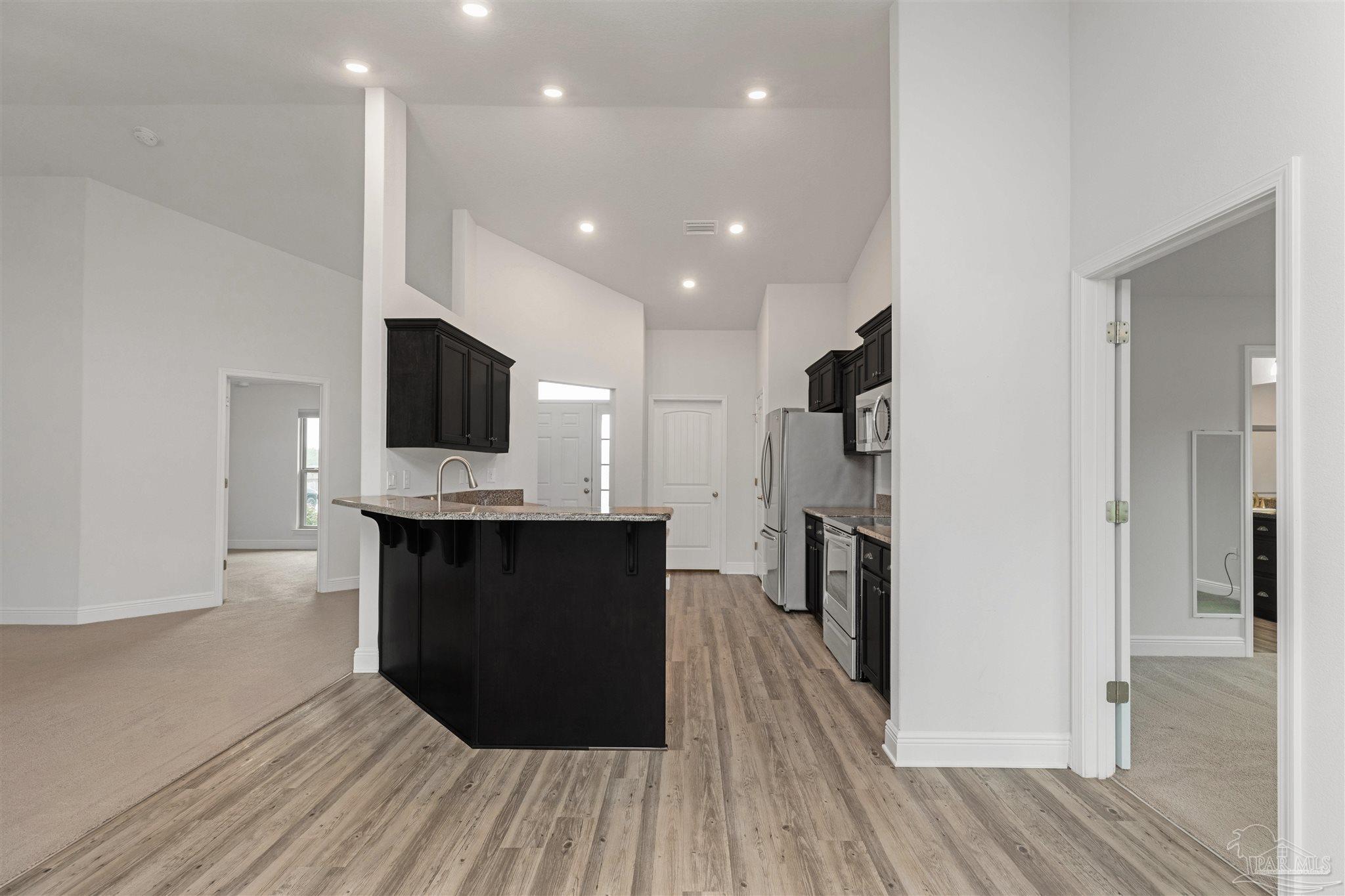 3626 Ranch Drive Crestview, FL 32539 - Photo 12 of 29 a kitchen with a refrigerator and a stove top oven