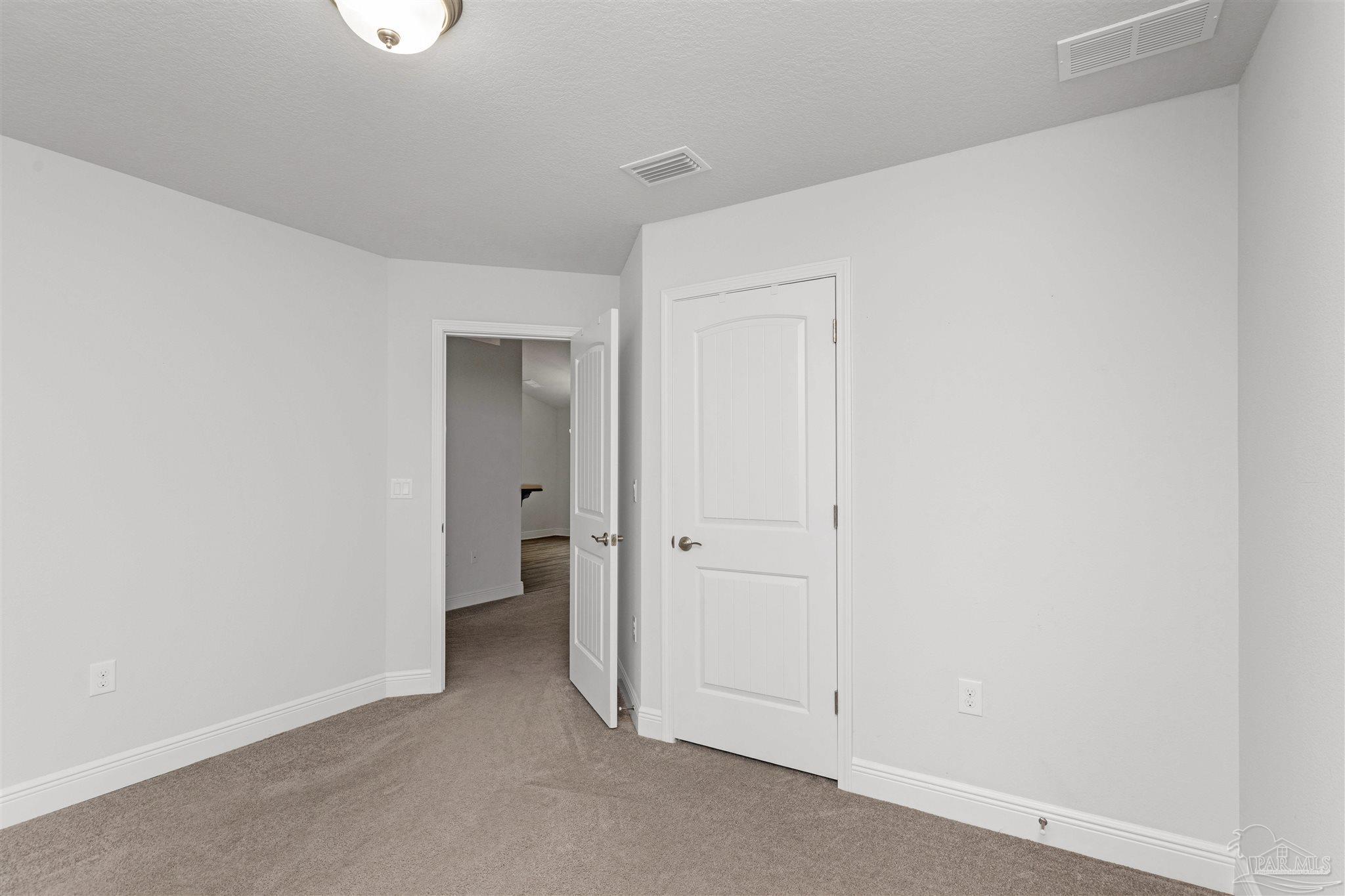 3626 Ranch Drive Crestview, FL 32539 - Photo 21 of 29 an empty room with a hallway