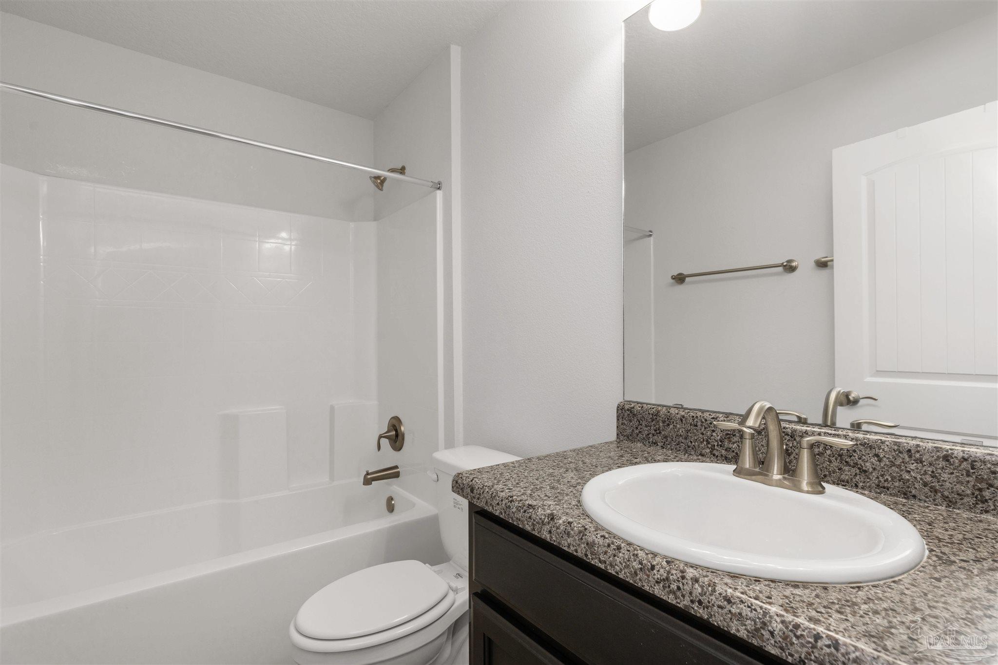 3626 Ranch Drive Crestview, FL 32539 - Photo 25 of 29 a bathroom with a granite countertop sink toilet and shower