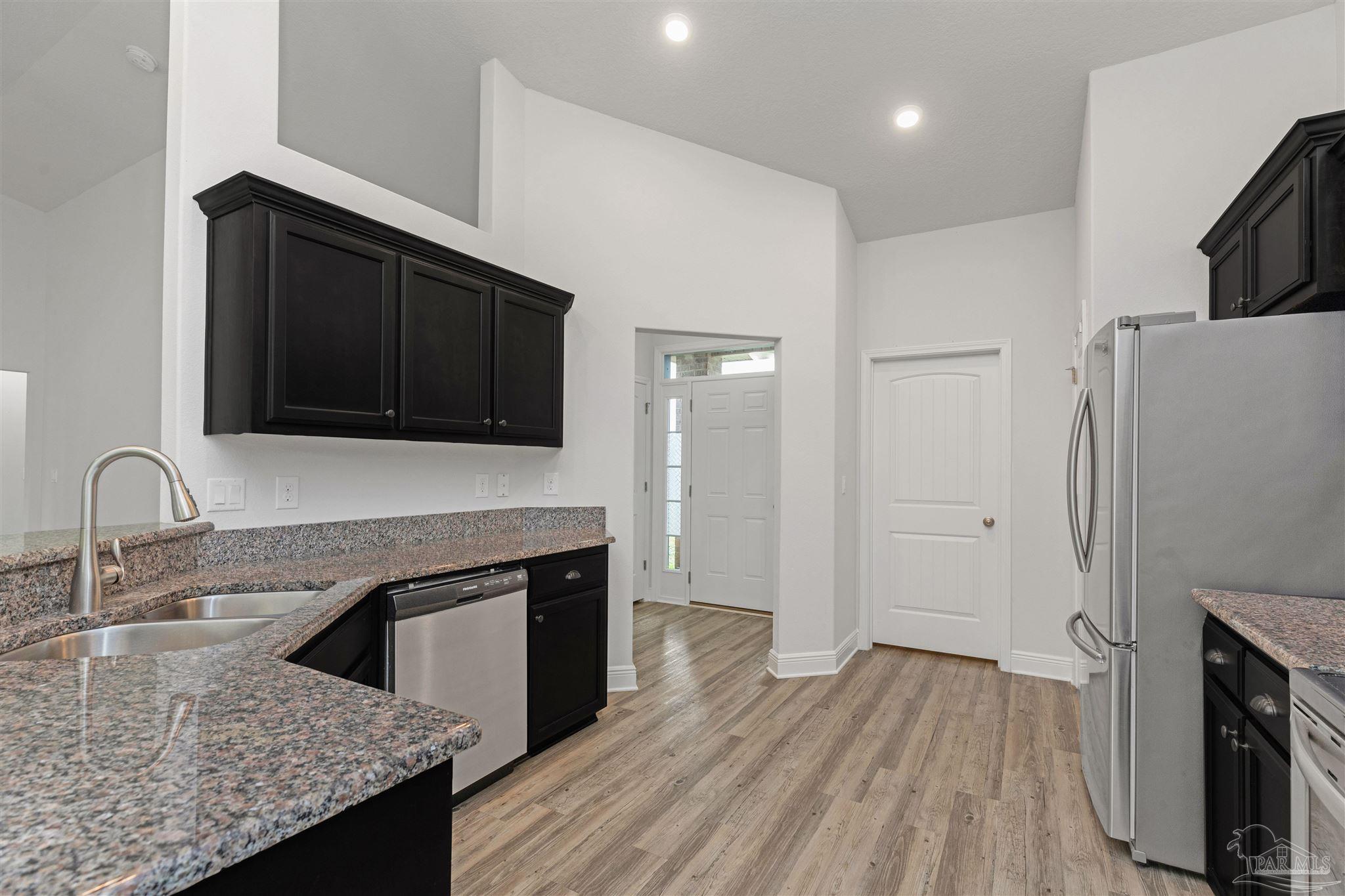 3626 Ranch Drive Crestview, FL 32539 - Photo 4 of 29 a kitchen with granite countertop wooden cabinets and a stainless steel appliances