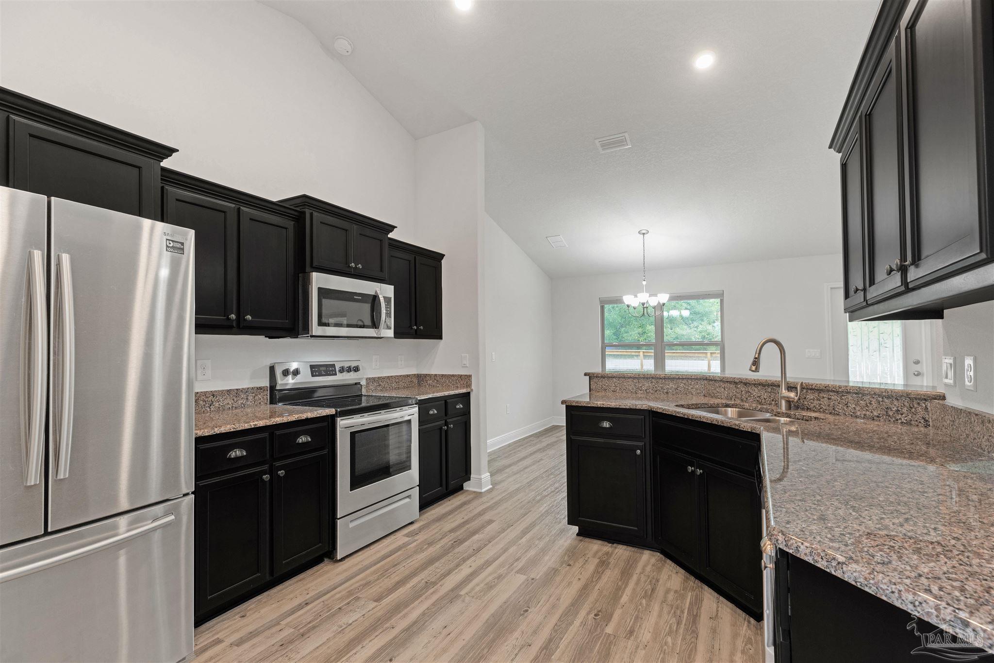 3626 Ranch Drive Crestview, FL 32539 - Photo 5 of 29 a kitchen with stainless steel appliances granite countertop a sink stove and refrigerator