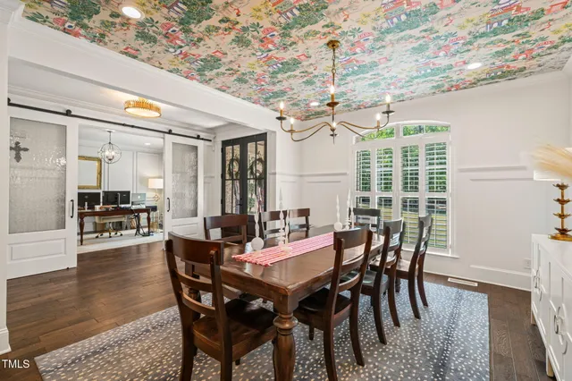 a kitchen with stainless steel appliances a refrigerator and a wooden floor