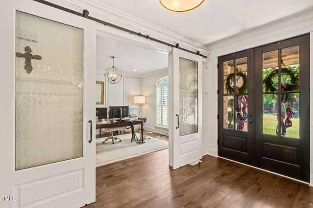 a kitchen with a dining table chairs cabinets and stainless steel appliances