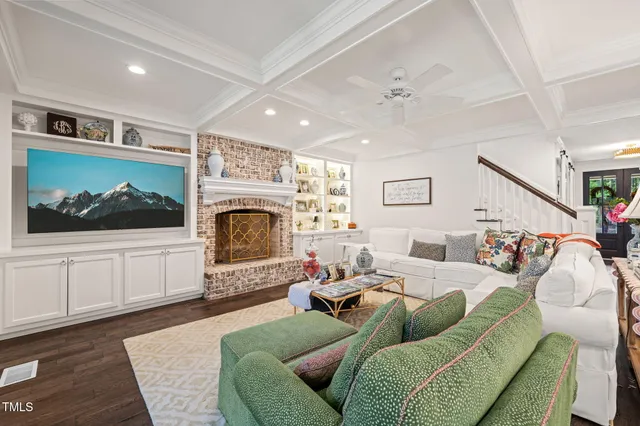 a bedroom with a bed chandelier and a window