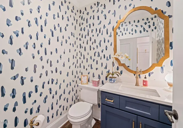 a bathroom with a toilet a sink and a large mirror