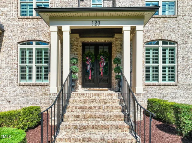 a aerial view of a house with a yard and potted plants