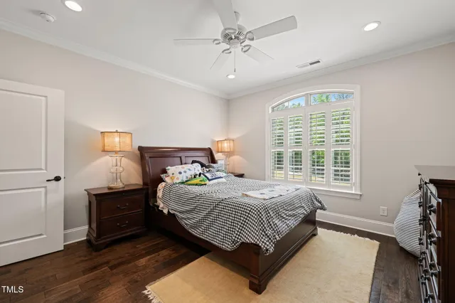 an aerial view of residential houses with outdoor space and trees