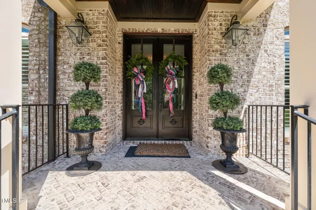 an aerial view of a house with pool yard and outdoor seating