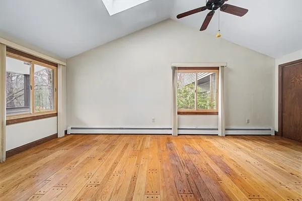 a view of empty room with a windows and fireplace