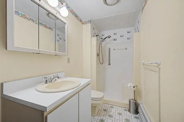 a bathroom with a toilet a sink and a mirror