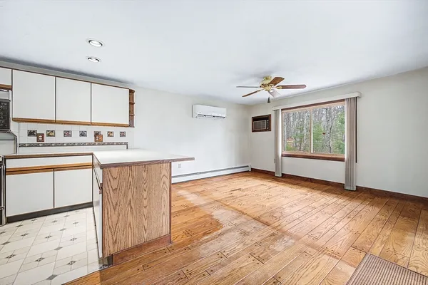 a view of an empty room with a fireplace and a window