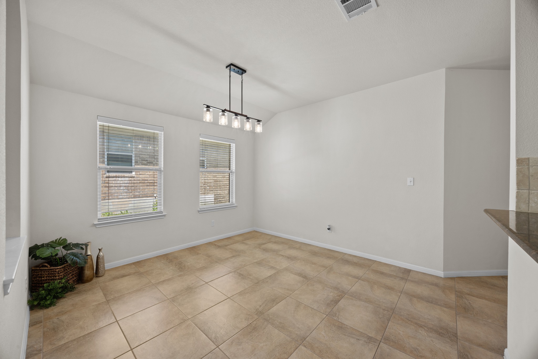 1317 Rimstone Drive Cedar Park, TX 78613 - Photo 11 of 32 Unfurnished dining area with lofted ceiling and light tile patterned floors