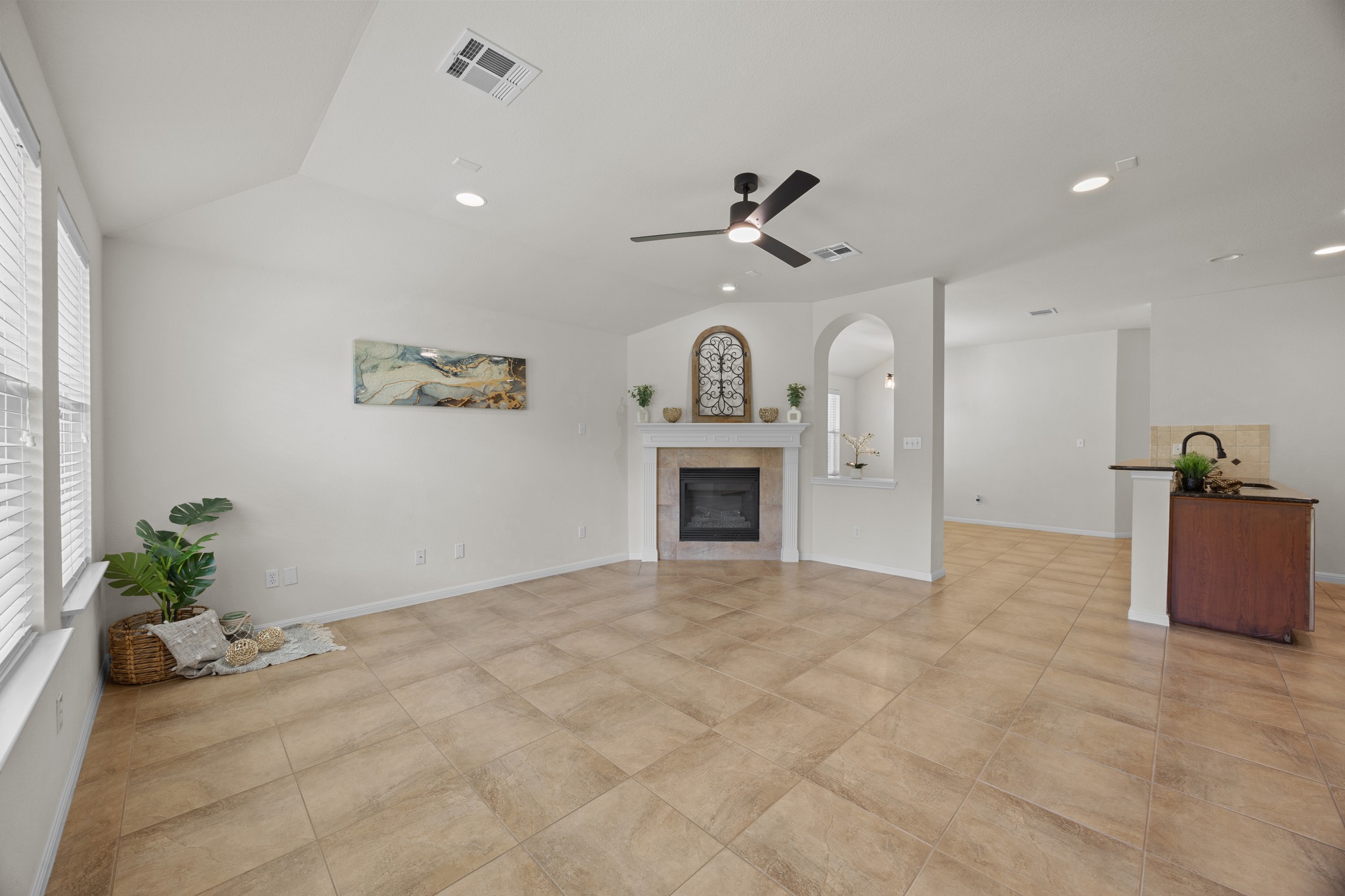 1317 Rimstone Drive Cedar Park, TX 78613 - Photo 13 of 32 Unfurnished living room featuring a ceiling fan, a fireplace, lofted ceiling, and recessed lighting