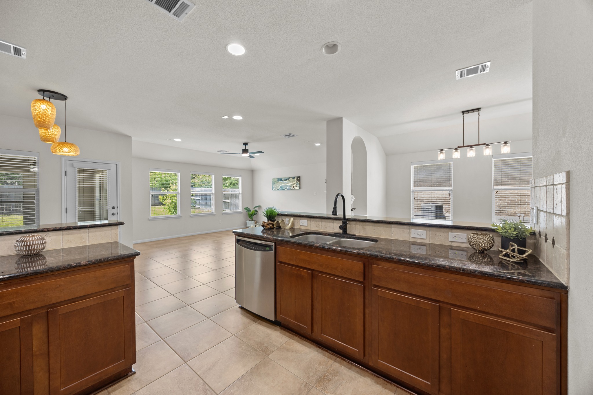 1317 Rimstone Drive Cedar Park, TX 78613 - Photo 18 of 32 Kitchen featuring pendant lighting, dark stone countertops, ceiling fan, and dishwasher
