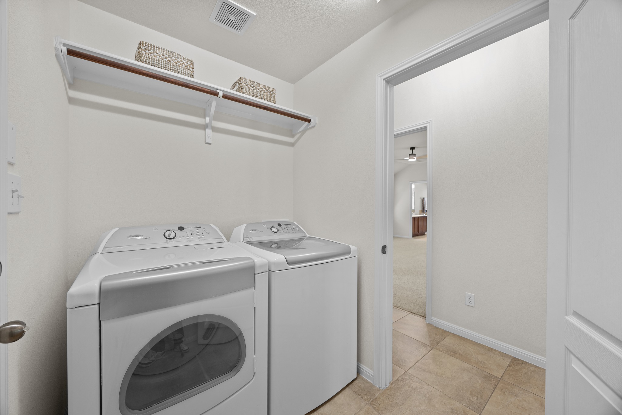 1317 Rimstone Drive Cedar Park, TX 78613 - Photo 19 of 32 Laundry room with washing machine and clothes dryer and light tile patterned floors