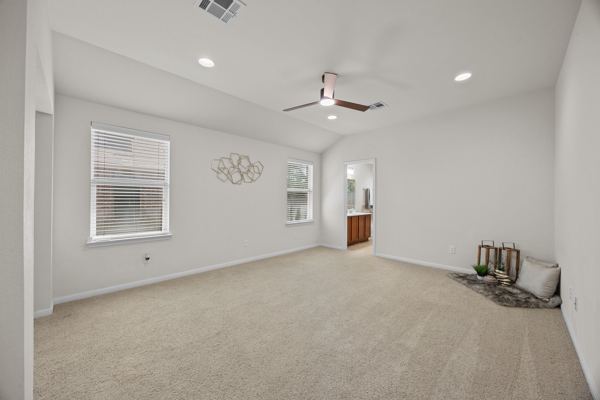 1317 Rimstone Drive Cedar Park, TX 78613 - Photo 20 of 32 Unfurnished bedroom with light carpet, lofted ceiling, recessed lighting, a ceiling fan, and ensuite bath