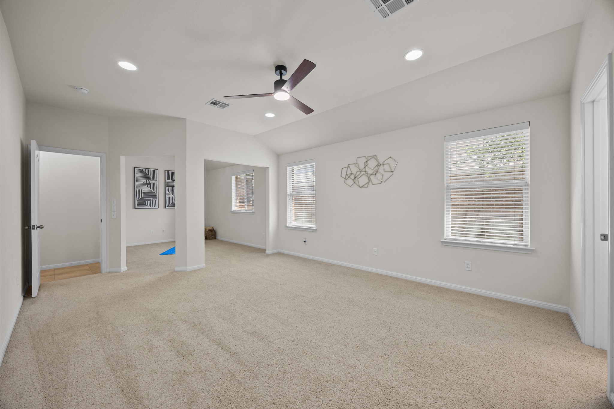 1317 Rimstone Drive Cedar Park, TX 78613 - Photo 22 of 32 Unfurnished bedroom with light carpet, a ceiling fan, lofted ceiling, and recessed lighting