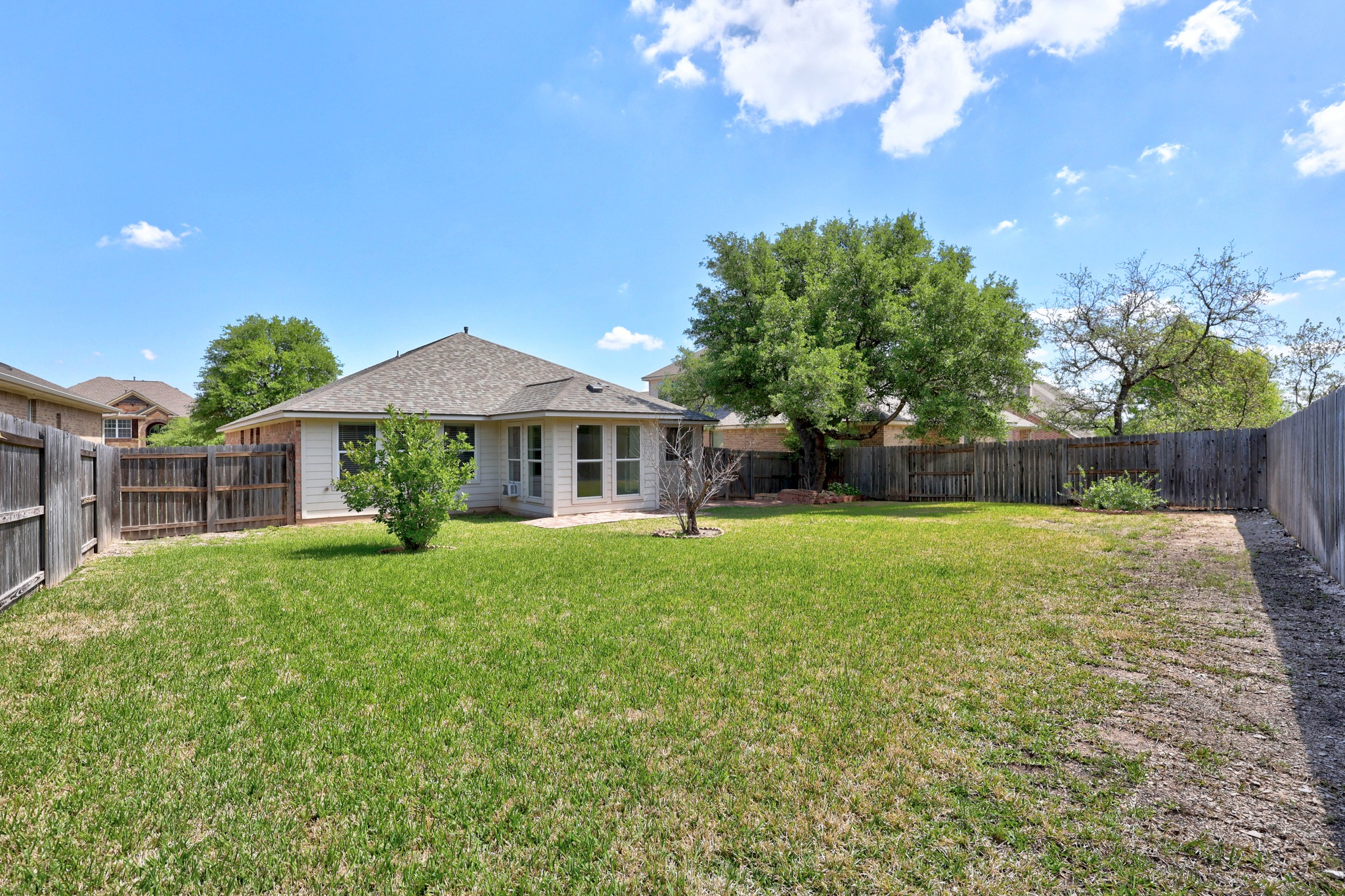 1317 Rimstone Drive Cedar Park, TX 78613 - Photo 30 of 32 Back of property with a fenced backyard and roof with shingles