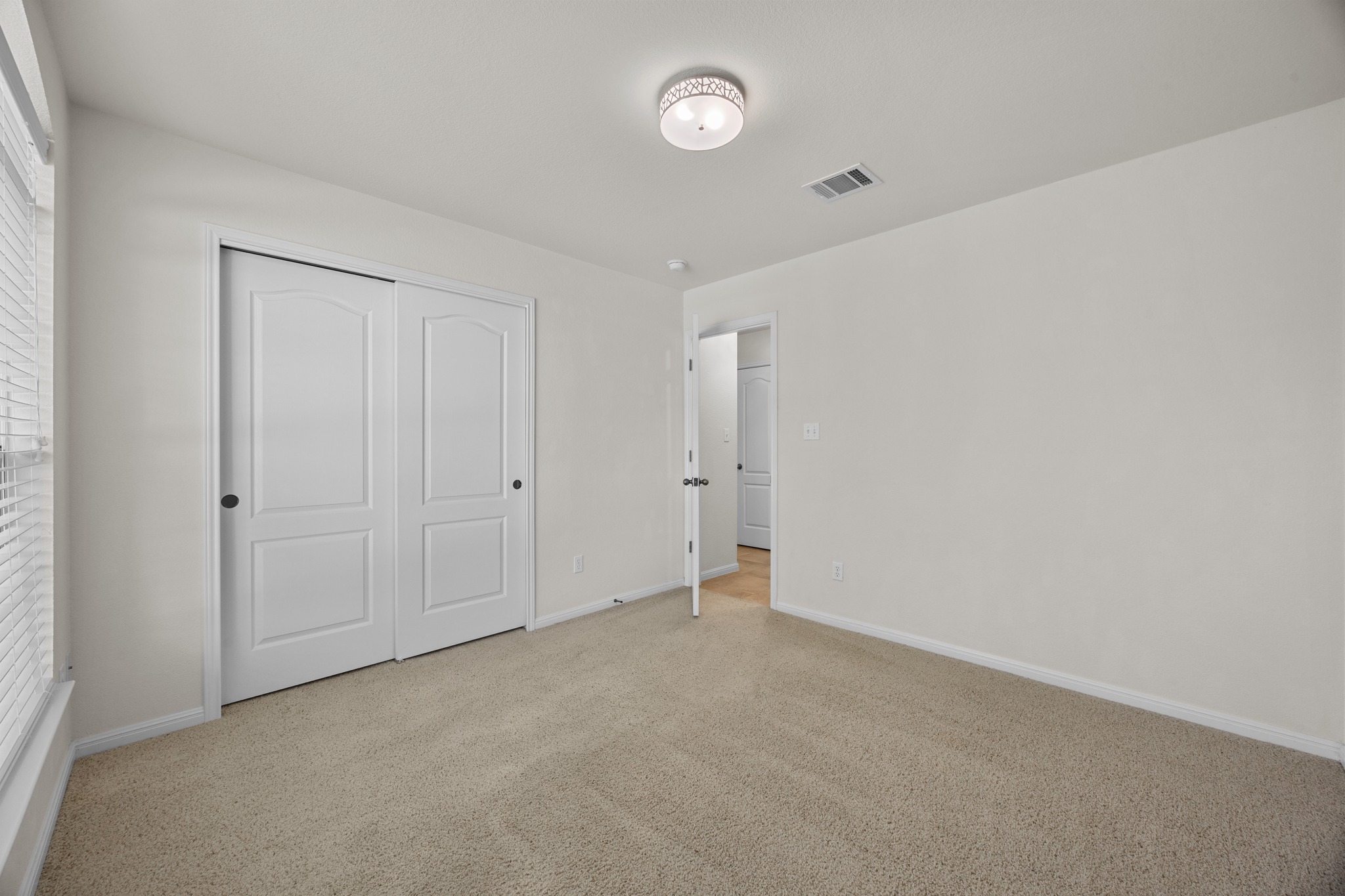 1317 Rimstone Drive Cedar Park, TX 78613 - Photo 6 of 32 Unfurnished bedroom with light colored carpet and a closet